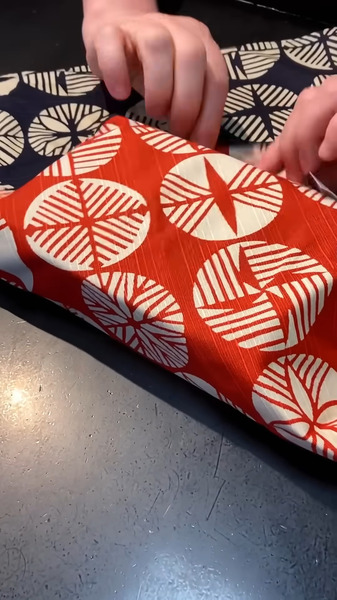 Step 1: Fold two opposite corners over the gift